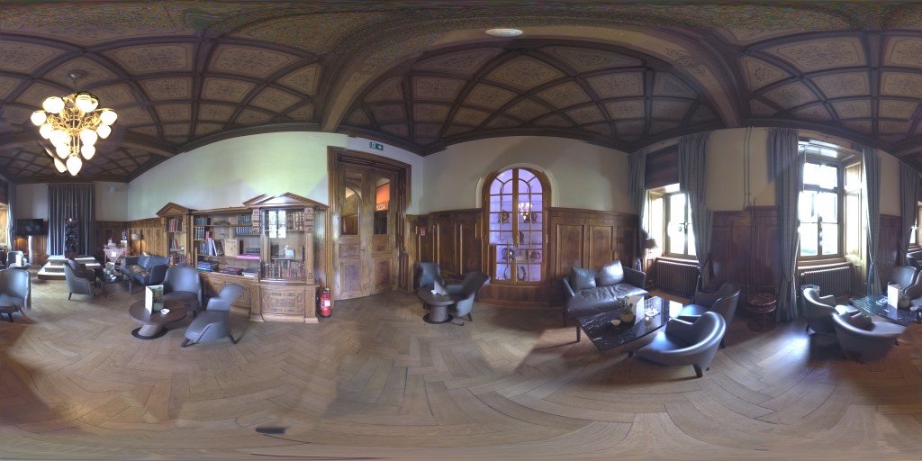 360° HDRI of a wood-panelled lounge with a chandelier, leather sofas and an arched window
